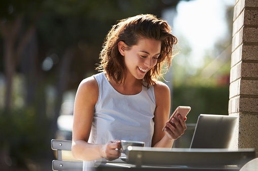 woman laughing at cellphone